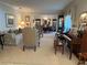 Spacious living area with a view into the dining room, featuring a piano and classic furnishings at 6703 Peachtree Dr, Temple Terrace, FL 33617