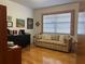 Cozy living room space features a comfortable couch and large window for natural light at 6703 Peachtree Dr, Temple Terrace, FL 33617