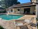 A refreshing outdoor pool, surrounded by brick pavers and comfortable seating, perfect for relaxation at 6703 Peachtree Dr, Temple Terrace, FL 33617