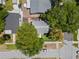 Overhead view of a well-maintained property with mature trees, a deck, and a pergola-covered patio at 701 14Th N St, St Petersburg, FL 33705