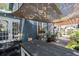Cozy back porch with pergola, sun shade, and French doors to the interior at 701 14Th N St, St Petersburg, FL 33705