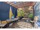 Back yard with seating, blue curtains, and pergola at 701 14Th N St, St Petersburg, FL 33705