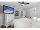 Bedroom with hardwood floors, ceiling fan, television, and neutral-colored walls at 701 14Th N St, St Petersburg, FL 33705