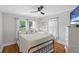 Bright bedroom featuring a ceiling fan, hardwood floors, and natural light from many windows at 701 14Th N St, St Petersburg, FL 33705