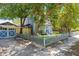 Exterior of the home featuring the driveway, garage, mature tree and fencing at 701 14Th N St, St Petersburg, FL 33705