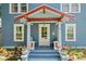 Inviting front porch with a colorful entrance, seating, and potted plants at 701 14Th N St, St Petersburg, FL 33705