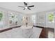 Bright living room featuring hardwood floors, neutral walls, and an open layout to the sunroom at 701 14Th N St, St Petersburg, FL 33705