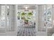 Charming sunroom with black and white tile flooring and decorative accents with lots of natural light at 701 14Th N St, St Petersburg, FL 33705
