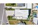 An aerial view of a home featuring a lush yard, pristine pool, and a rooftop deck at 706 S Davis Blvd, Tampa, FL 33606