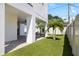 Spacious backyard with artificial grass, modern pool, covered patio area, and privacy fence, ideal for outdoor living at 706 S Davis Blvd, Tampa, FL 33606
