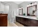 Bright bathroom featuring double sinks, granite countertops, and neutral paint at 706 S Davis Blvd, Tampa, FL 33606