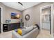 Cozy bonus room featuring a couch, ottoman, tv, wet-bar, and access to the bathroom at 706 S Davis Blvd, Tampa, FL 33606