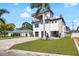 Contemporary three-story home with private balconies and a well-maintained front lawn at 706 S Davis Blvd, Tampa, FL 33606