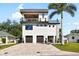 Stunning three-story home with private balconies, a two-car garage, and a beautiful paver driveway at 706 S Davis Blvd, Tampa, FL 33606