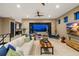 Open concept living room with stone accent wall, modern furnishings, and expansive doors leading to an outdoor terrace at 706 S Davis Blvd, Tampa, FL 33606
