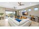 Bright living room with a large sectional sofa, marble floors, and access to an outdoor patio at 706 S Davis Blvd, Tampa, FL 33606