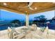 Covered outdoor patio with comfortable seating, a ceiling fan, stone columns, and a stunning view of the city skyline at 706 S Davis Blvd, Tampa, FL 33606