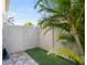 Enclosed outdoor shower area with stone pavers, artificial turf, and privacy fence, perfect for rinsing off after a swim at 706 S Davis Blvd, Tampa, FL 33606