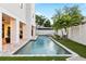 Backyard pool and spa with a modern outdoor design, palm trees, and brick patio at 706 S Davis Blvd, Tampa, FL 33606