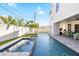 An inviting pool area with lounge chairs, well-manicured lawn and a modern home facade at 706 S Davis Blvd, Tampa, FL 33606