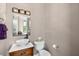 Stylish powder room featuring a modern vessel sink, wood cabinet, decorative mirror, and neutral color scheme at 706 S Davis Blvd, Tampa, FL 33606