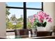 Close-up view of a cityscape through the dining room window with a decorative orchid in the foreground at 706 S Davis Blvd, Tampa, FL 33606