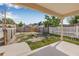 Spacious backyard with a mix of grass and sand, a fence, and a concrete patio at 718 30Th N Ave, St Petersburg, FL 33704