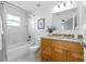 Bright bathroom features a shower-tub combo, modern vanity, and decorative mirror at 718 30Th N Ave, St Petersburg, FL 33704