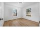 A sun filled bedroom with wood laminate floors and light neutral walls at 718 30Th N Ave, St Petersburg, FL 33704