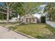 Beautiful home with a well-manicured front yard, mature trees, and a welcoming entrance at 718 30Th N Ave, St Petersburg, FL 33704