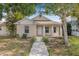 Charming home with stucco exterior, inviting front porch, and landscaped walkway at 718 30Th N Ave, St Petersburg, FL 33704