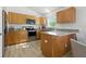 Modern kitchen with granite countertops, stainless steel appliances, and wooden cabinetry at 718 30Th N Ave, St Petersburg, FL 33704