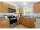 Well-lit kitchen featuring stainless steel appliances and wooden cabinets at 718 30Th N Ave, St Petersburg, FL 33704