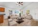 Bright living room features wood floors, ceiling fan, and ample seating for a comfortable and inviting feel at 718 30Th N Ave, St Petersburg, FL 33704