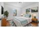 Comfortable main bedroom with wood floors, natural light, and stylish decor at 718 30Th N Ave, St Petersburg, FL 33704