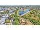 Aerial view of the community playground, pond, and walking path amidst lush landscaping and colorful homes at 729 Manns Harbor Drive, Apollo Beach, FL 33572