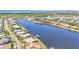 Aerial view of waterfront homes and canals with boat docks, mature landscaping, and lush foliage at 729 Manns Harbor Drive, Apollo Beach, FL 33572