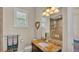 Well-lit bathroom featuring granite countertops, a shower, and white fixtures at 729 Manns Harbor Drive, Apollo Beach, FL 33572