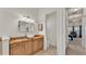 Bathroom with custom vanity and a hallway view leading to the main bedroom at 729 Manns Harbor Drive, Apollo Beach, FL 33572