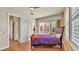 Bright bedroom featuring wood floors, modern furniture, and sliding glass doors to the pool at 729 Manns Harbor Drive, Apollo Beach, FL 33572