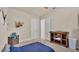 Bright bedroom with carpet, doors to the closet and bathroom and nautical decor at 729 Manns Harbor Drive, Apollo Beach, FL 33572