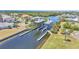 View of boat lift on waterfront canal with lush landscaping and upscale neighborhood at 729 Manns Harbor Drive, Apollo Beach, FL 33572