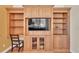 Custom wooden built-in shelves with workspace desk and decorative display cases at 729 Manns Harbor Drive, Apollo Beach, FL 33572
