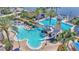 Aerial view showcasing a community pool with a lighthouse slide, Gathering-friendly water features and abundant seating at 729 Manns Harbor Drive, Apollo Beach, FL 33572