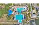 Aerial view of a resort-style community pool area featuring multiple pools, spas, and a splash pad at 729 Manns Harbor Drive, Apollo Beach, FL 33572