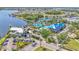 Aerial view of a vibrant community pool area with a clubhouse, lounge chairs, and tropical landscaping at 729 Manns Harbor Drive, Apollo Beach, FL 33572