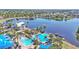 Aerial view of a luxurious community pool complex with a lap pool, recreational pool, and waterfront access at 729 Manns Harbor Drive, Apollo Beach, FL 33572