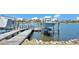 Boat and Boat Lift on dock with stunning waterfront views of calm lake at 729 Manns Harbor Drive, Apollo Beach, FL 33572