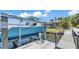 Boat lift and boat with view of gorgeous lakefront home and lush landscaping at 729 Manns Harbor Drive, Apollo Beach, FL 33572