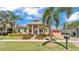 Inviting single-story home with lush landscaping and a well-kept lawn at 729 Manns Harbor Drive, Apollo Beach, FL 33572